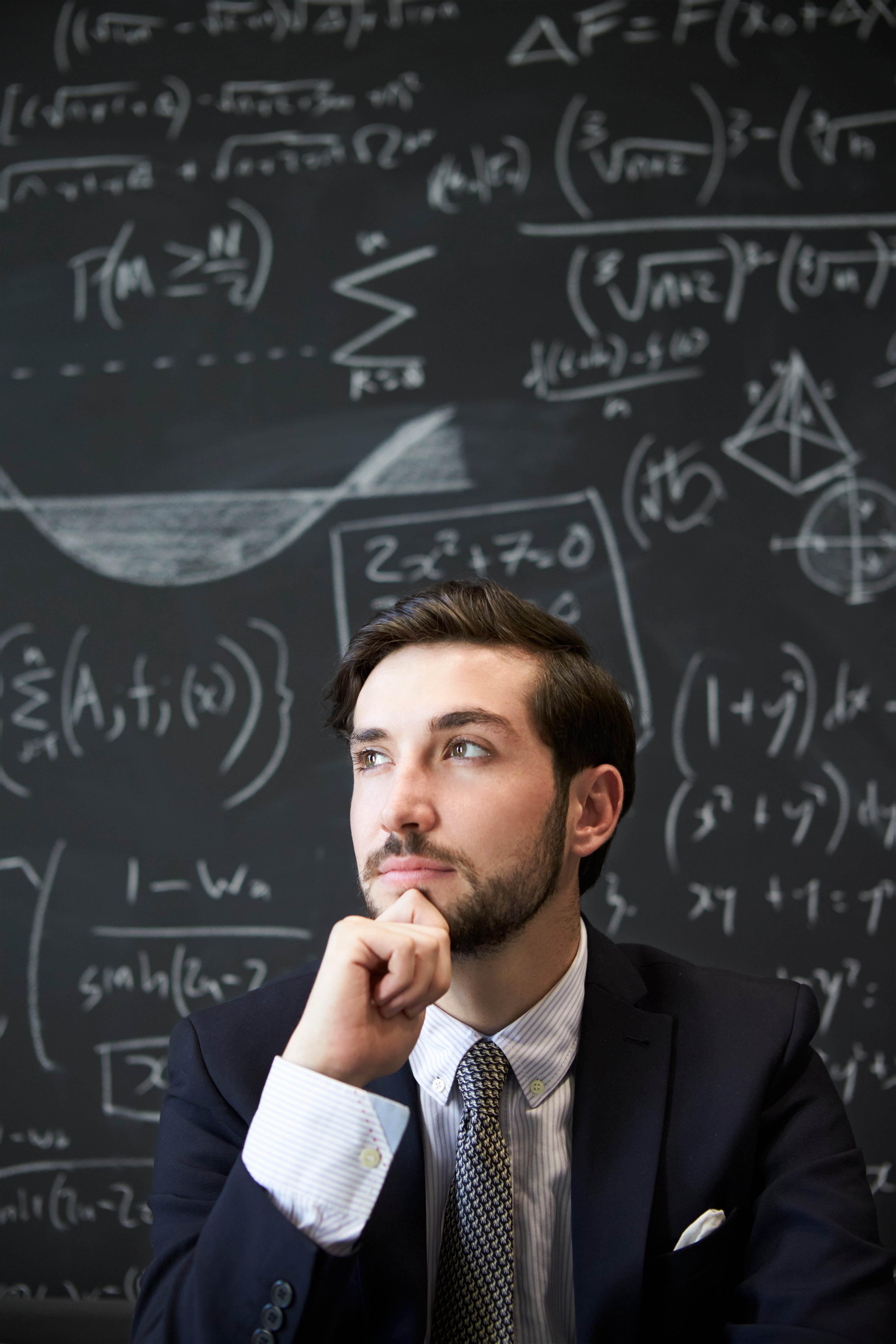 young-man-contemplaiting-in-front-of-blackboard-2026-01-05-22-55-42-utc